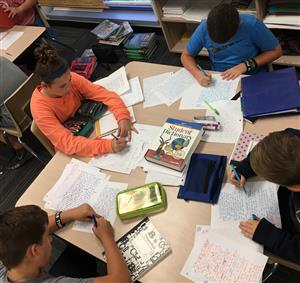 students working in a group writing 
